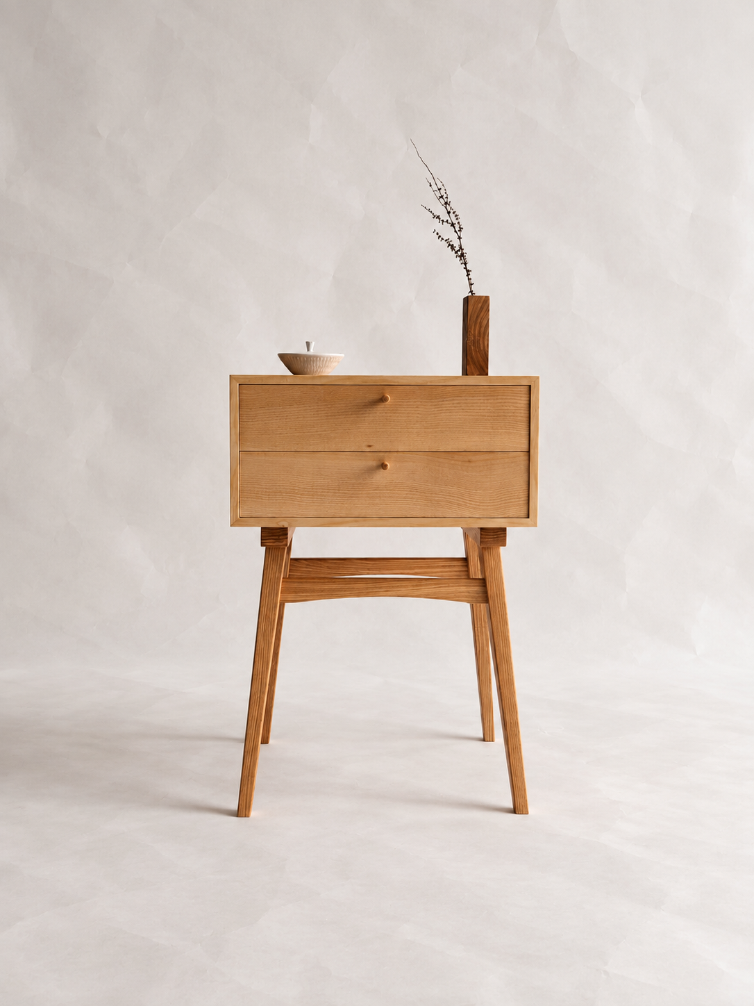 Front view of the Chowa Side Stand with two drawers and a small vase