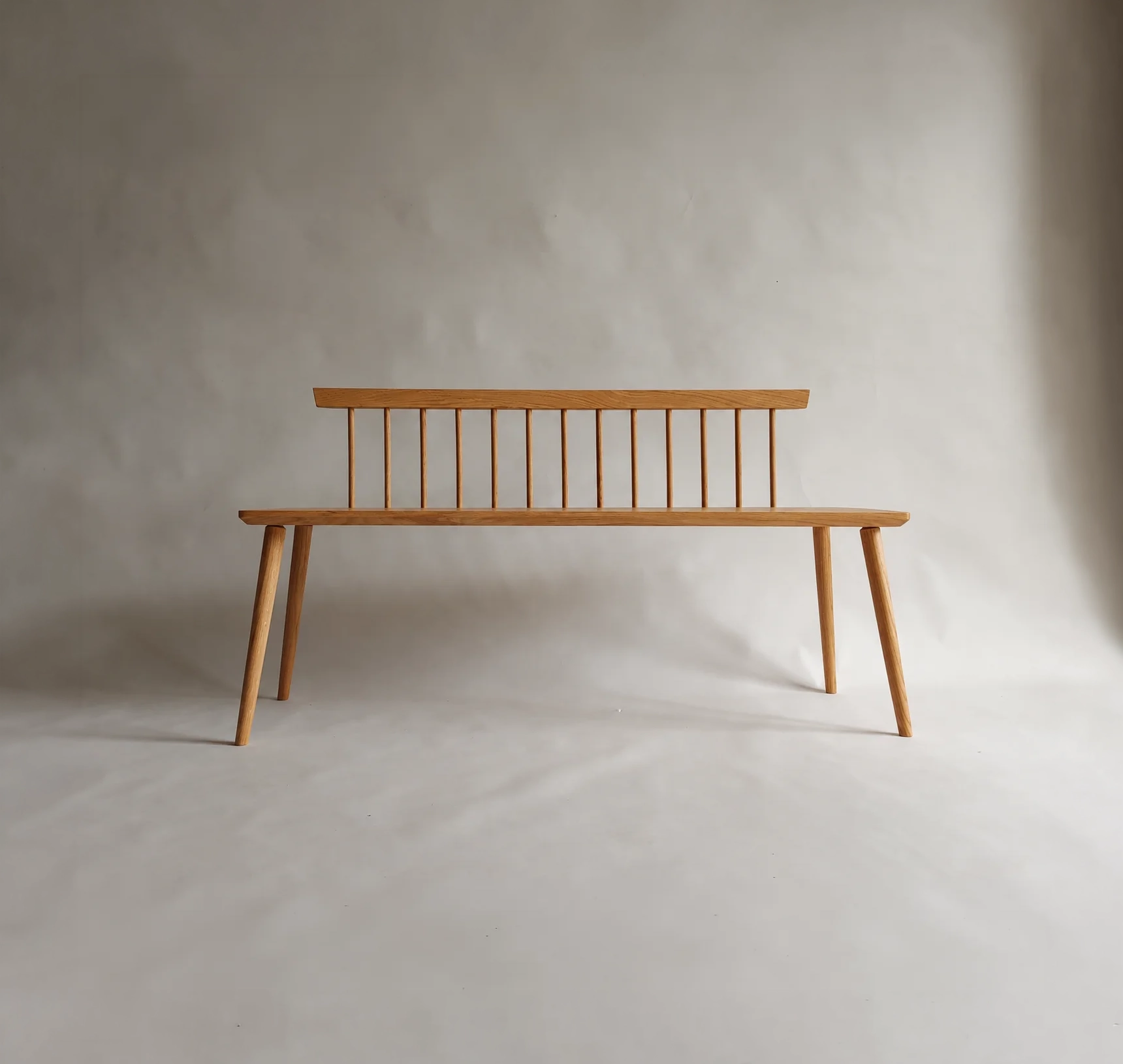Nokori Bench with spindle back and splayed timber legs