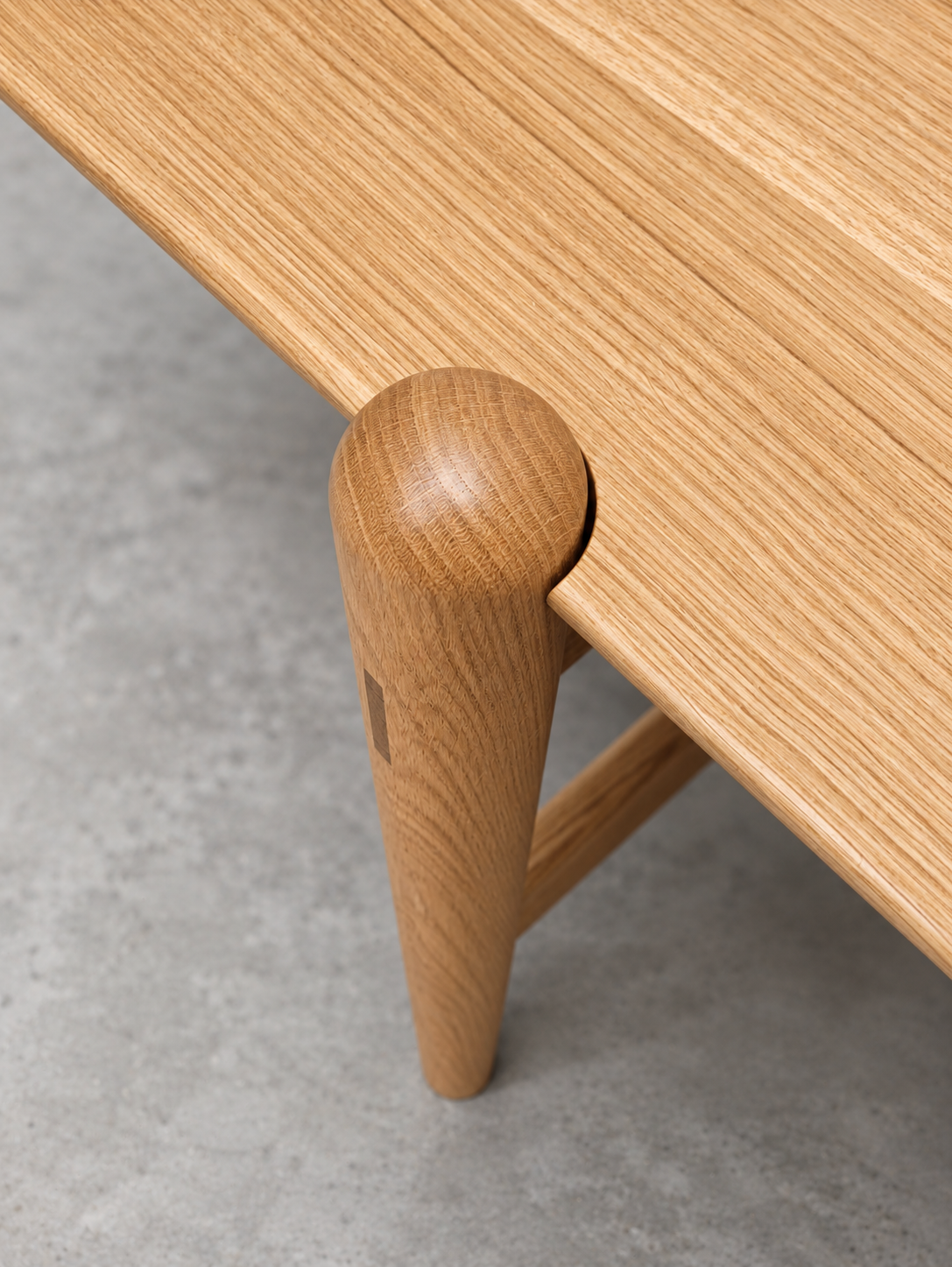 Shibui Table rounded leg meeting the edge of the tabletop