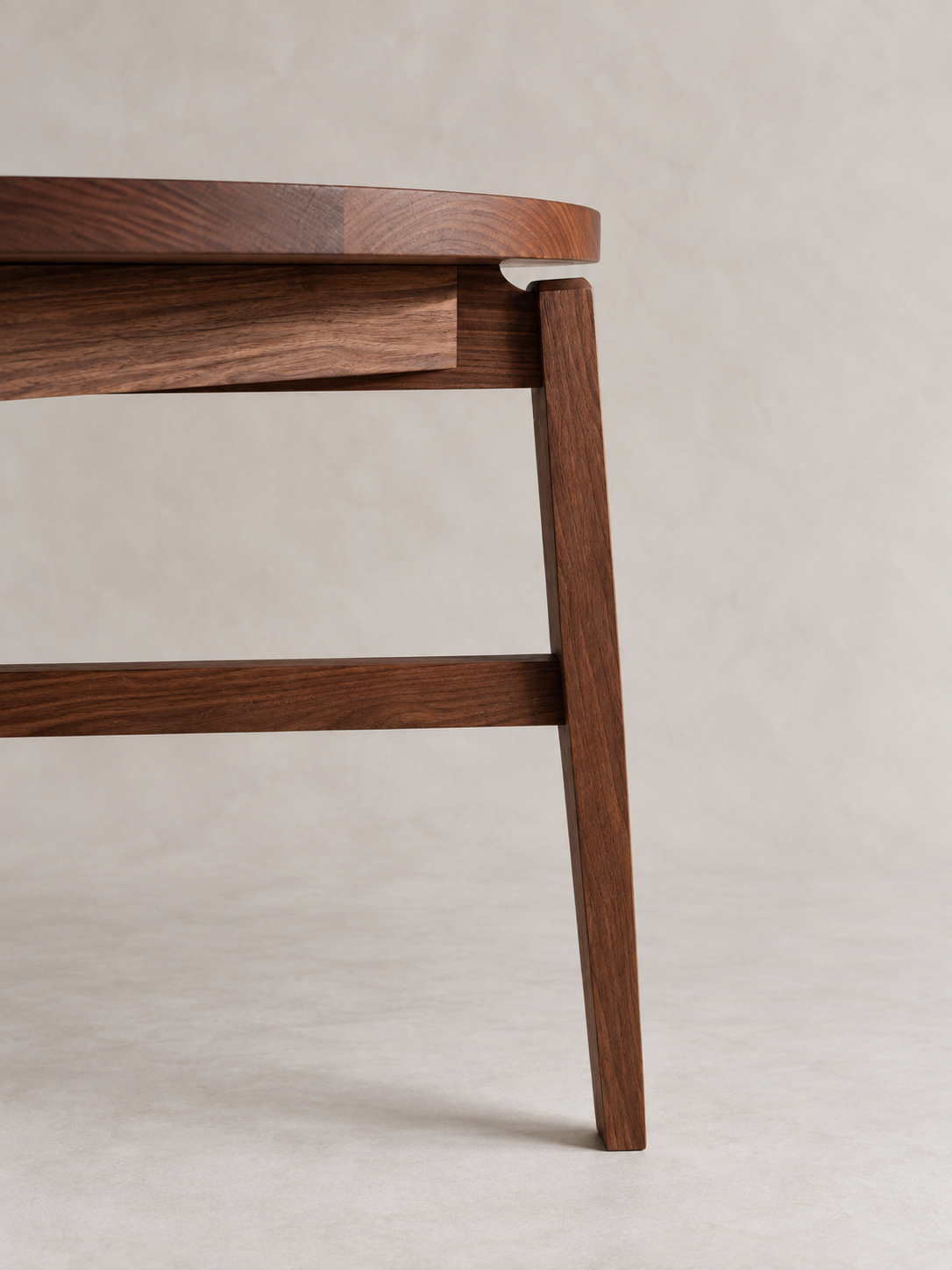 Side view of the Tsiki Table showing its round top and tapered leg