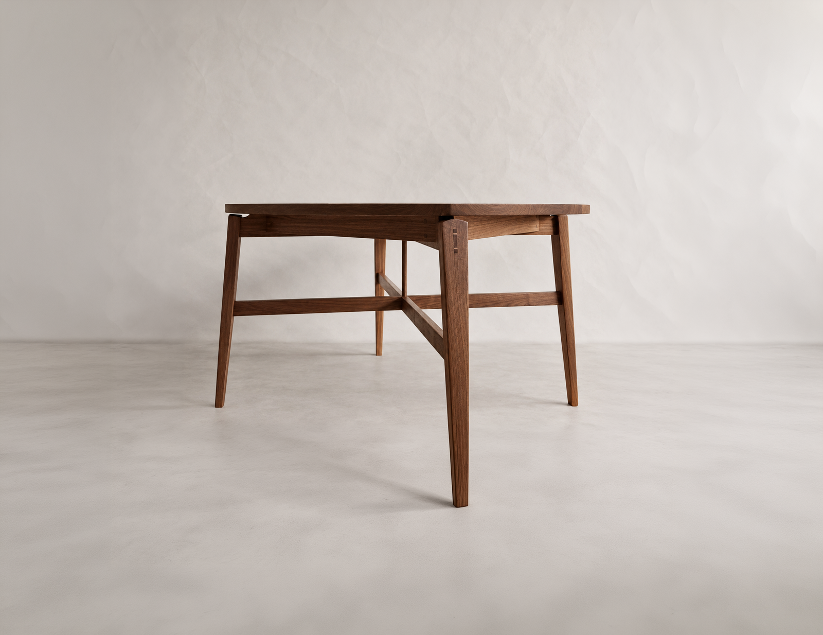 Three-quarter view of the Tsiki Table with circular top and shaped legs