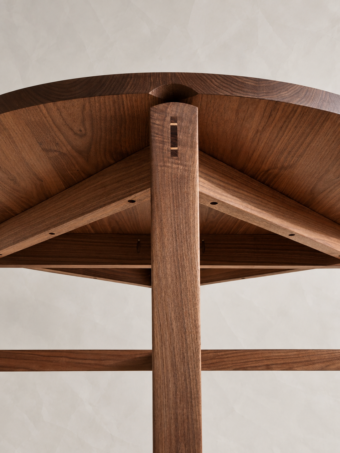 Underside of the Tsiki Table showing the curved apron and leg joinery