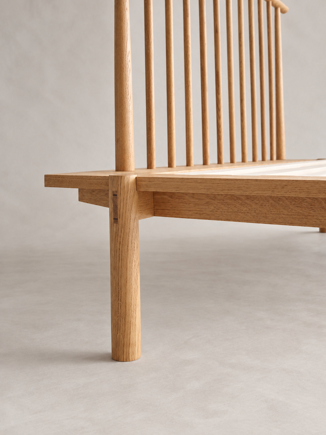 Yatta Bed headboard corner and rounded timber leg