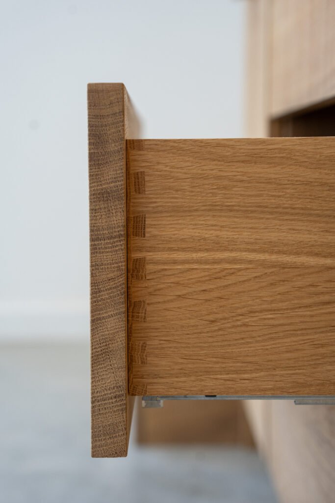 Close-up of dovetail joints at the corner of an oak drawer at Camber Sands Pool House