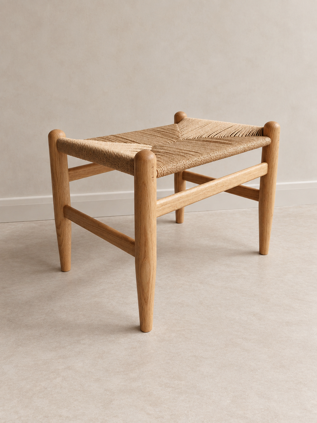 Three-quarter view of the Pett Stool with woven Danish cord seat